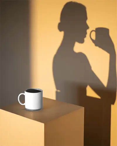 Minimalist Coffee Mug Mockup With Shadow Profile Of Person Holding A Cup In Soft Warm Light