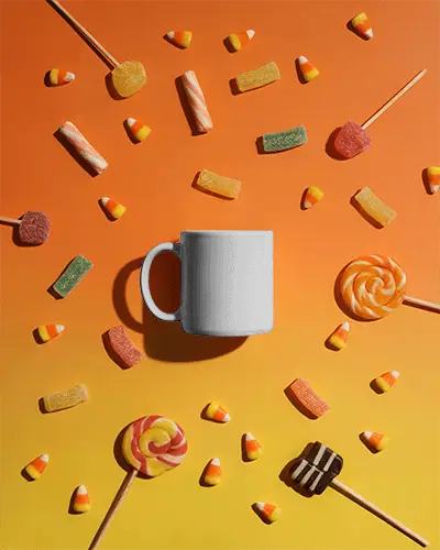 Spooky Halloween Mug Mockup With Scattered Candy For Seasonal Design
