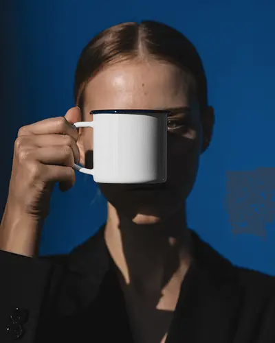 Sunlit Fashion Portrait Mug Mockup Held Forward In Clean Blue Backdrop