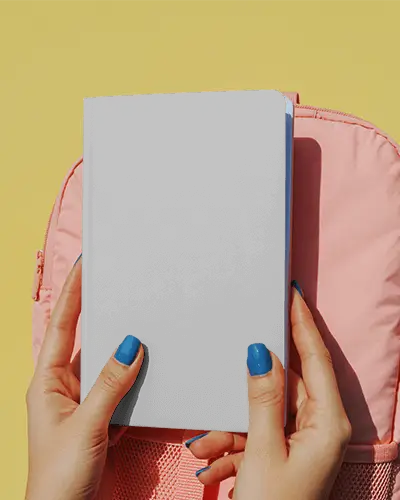 Bright Back To School Notebook Mockup Held In Hands With Pink Backpack On Yellow Background