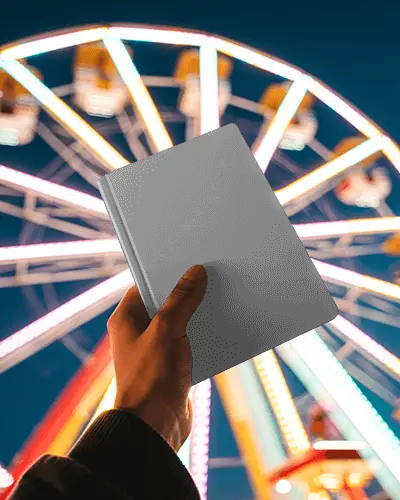 Night Fair Notebook Mockup Held Up With Bright Ferris Wheel Lights In Background
