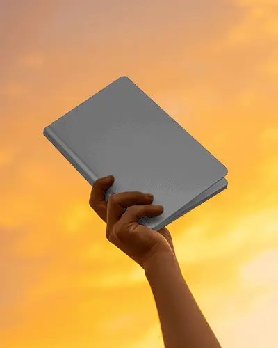Glowing Sunset Notebook Mockup With Hand Raised Toward Warm Evening Light