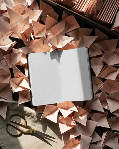 Origami Craft Open Notebook Mockup Surrounded By Folded Paper And Warm Light