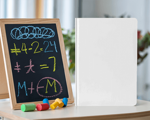 Colorful Classroom Notebook Mockup Next To Chalkboard With Math Equations And Toy Crayons Educational And Playful Setting 0016