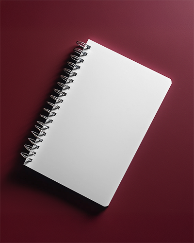 spiral-notebook-mockup-angled-top-view-white-cover-on-deep-burgundy-background-modern-and-elegant-stationery-presentation-023