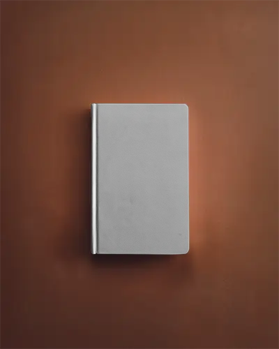 front-view-closed-notebook-mockup-on-warm-toned-background-clean-and-elegant-presentation-for-cover-design
