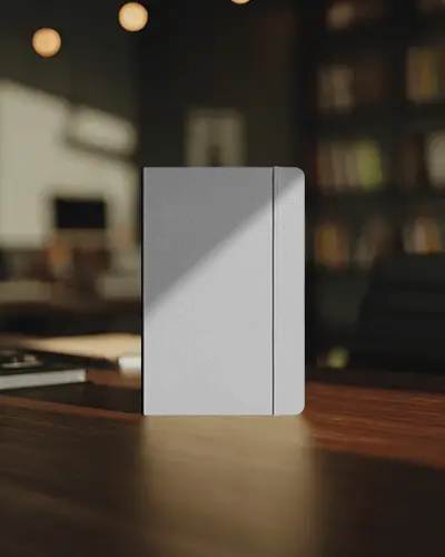 standing-notebook-mockup-on-wooden-desk-in-cozy-library-with-soft-bokeh-lighting