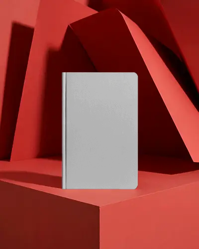 vertical-notebook-mockup-on-geometric-red-background-with-modern-artistic-folded-shapes