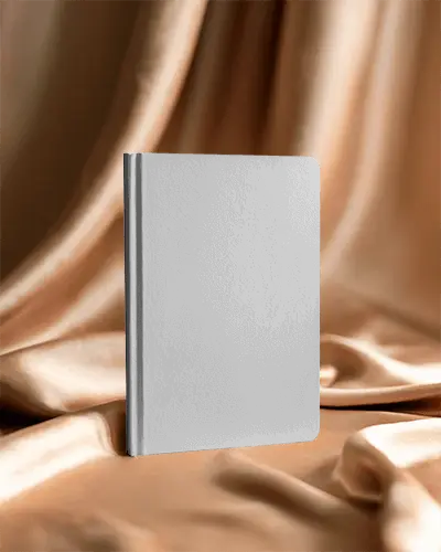 sleek-notebook-mockup-standing-over-luxurious-draped-fabric-backdrop-for-design-presentation