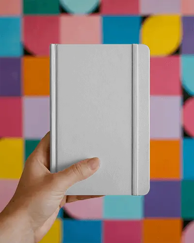 Hand Holding Blank Notebook Mockup In Portrait For Business Notes And Planning Mockup Template