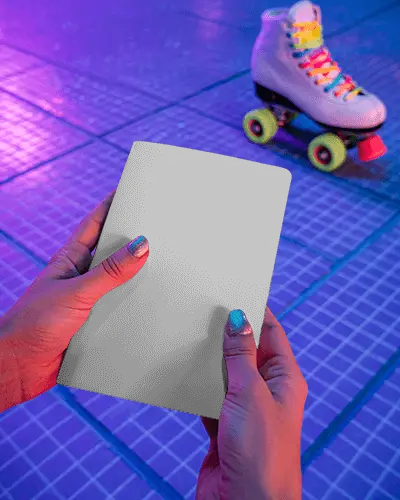 Neon Roller Rink Notebook Mockup Held In Hands With Vibrant Retro Skate Atmosphere
