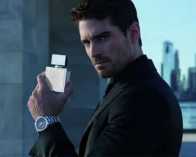 Confident Male Model Holding Luxury Perfume Bottle In Cityscape Background Stylish Modern Look