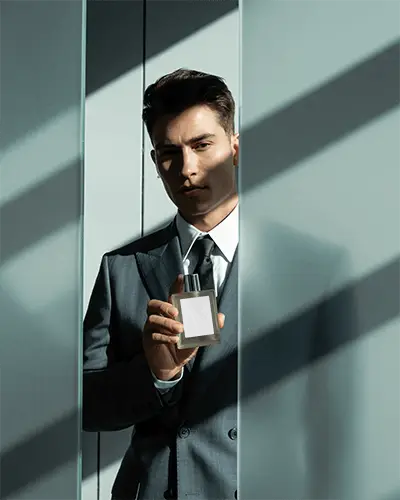 Modern Masculine Perfume Mockup Man In Suit Holding Fragrance In Stylish Light And Shadow