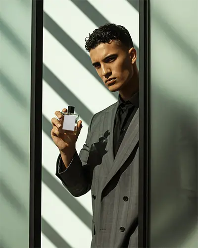 Luxury Men Fragrance Mockup Elegant Male Model Holding Bottle In Shadow Lines