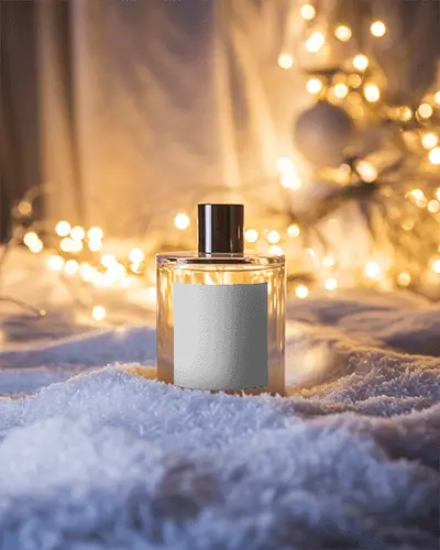 Christmas Perfume Mockup Glass Bottle In Snow With Golden Fairy Lights And Festive Glow