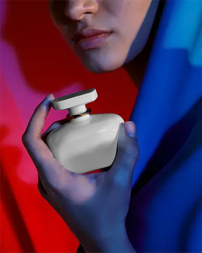 Luxury Elegant Perfume Bottle Mockup Held By Feminine Hand Against Vibrant Background