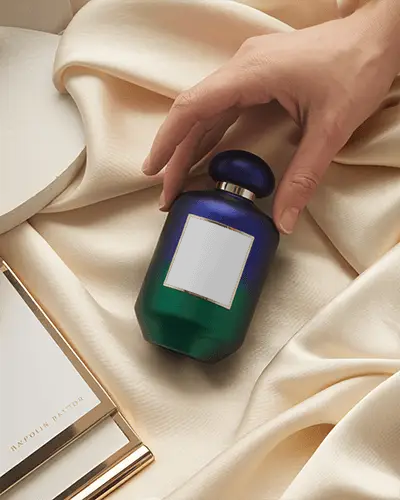 Elegant Duotone Perfume Mockup Held On Soft Ivory Fabric With Luxury Styling Accents