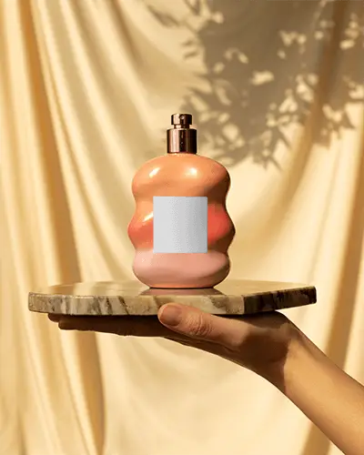 Sculpted Peach Perfume Mockup On Marble Platform In Warm Sunlit Drape Setting