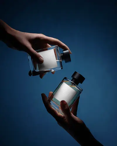 Hand Held Perfume Mockup Dual Glass Bottles Dark Blue Background Dramatic Lighting
