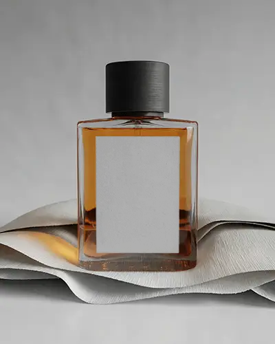 Minimalist Perfume Mockup Amber Glass Bottle On Layered Fabric Soft Grey Studio Light