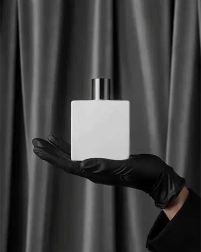 Moody Elegance Perfume Mockup Of Square Bottle Suspended By Gloved Hand Against Rich Dark Fabric Folds