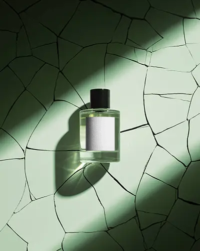 luxury-perfume-mockup-glass-bottle-design-on-cracked-green-stone-background