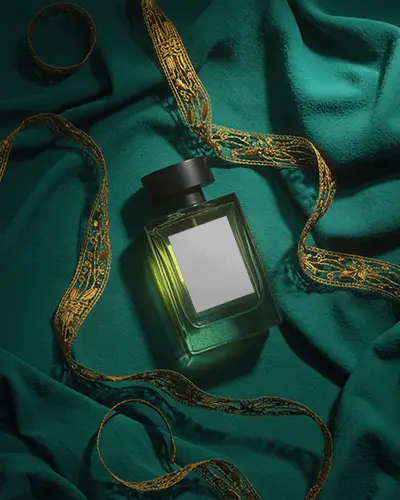 luxury-perfume-mockup-glass-bottle-on-emerald-fabric-with-golden-ribbon