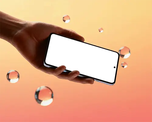 Hand Holding Modern Phone Mockup Against Gradient Background With Floating Transparent Bubbles