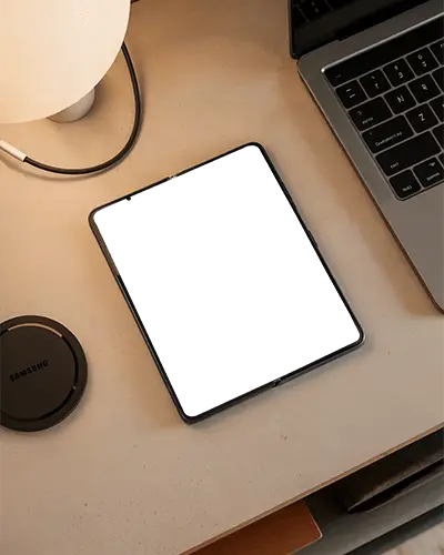 Samsung Modern Foldable Phone Mockup On Clean Desk Next To Laptop And Wireless Charging Pad