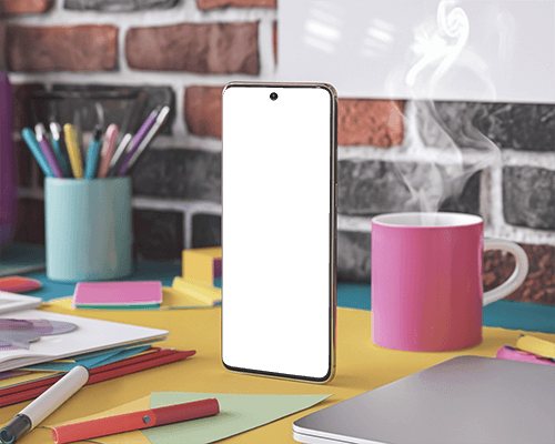 Creative Desk Smartphone Mockup With Colorful Stationery And Steaming Coffee Mug