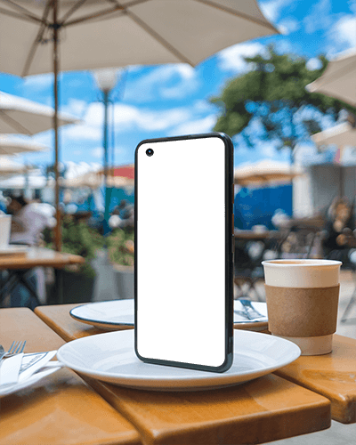 Outdoor Cafe Smartphone Mockup On Table With Coffee Cup And Blue Sky Background