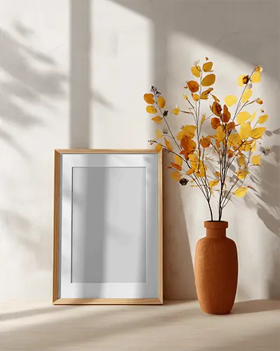 Elegant Frame Mockup With Autumnal Dried Leaves Arrangement And Subtle Shadow Play On Wall