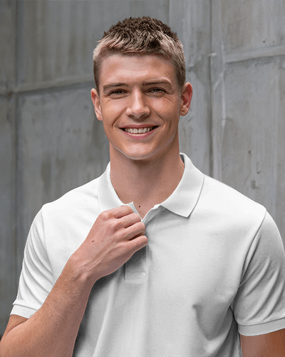 Modern Blank White Men Polo T Shirt Mockup Smiling Male Model Against Industrial Gray Wall Casual And Stylish Look