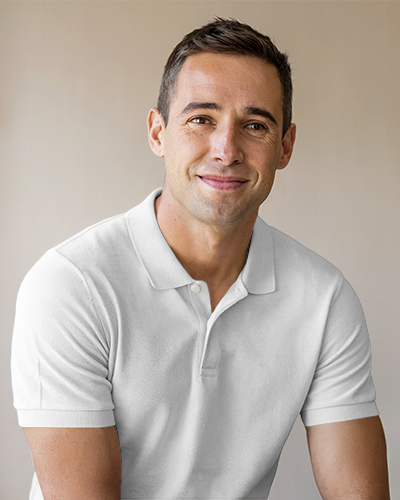 Modern Polo Shirt Mockup Smiling Male Model In Light Pink Polo With Coffee Themed Design Against Neutral Background Casual And Approachable Look