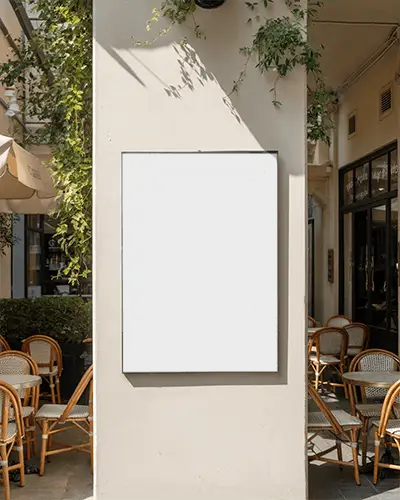 Street Wall Mounted Poster Mockup Surrounded By Cafe Chairs And Tables