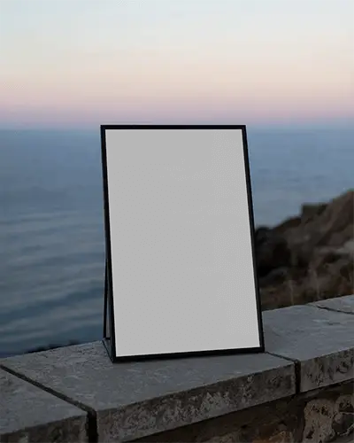 modern-frame-poster-mockup-standing-on-stone-wall-with-ocean-background