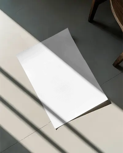 blank-paper-poster-mockup-placed-on-floor-with-wooden-chair-and-long-light-beams
