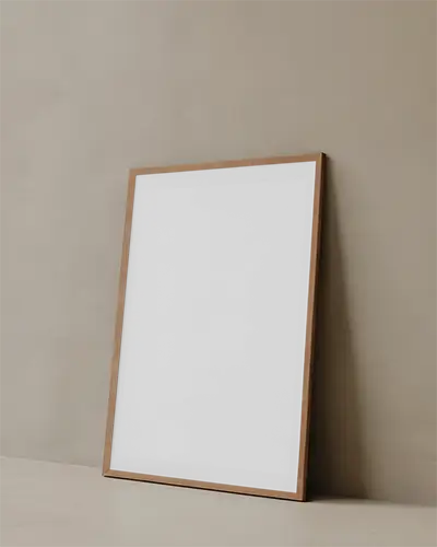 minimalist-blank-poster-mockup-with-wooden-frame-leaning-on-textured-wall-surface
