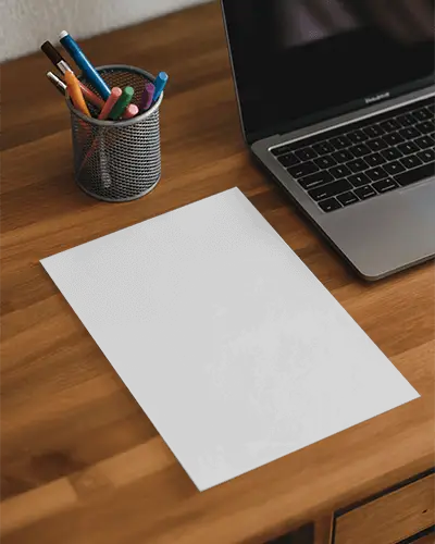 Blank Poster Mockup On Wooden Desk With Laptop And Pen Holder For Design Display