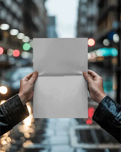 Urban Streetstyle Hands Holding Folded Poster Mockup Rainy City Bokeh Background