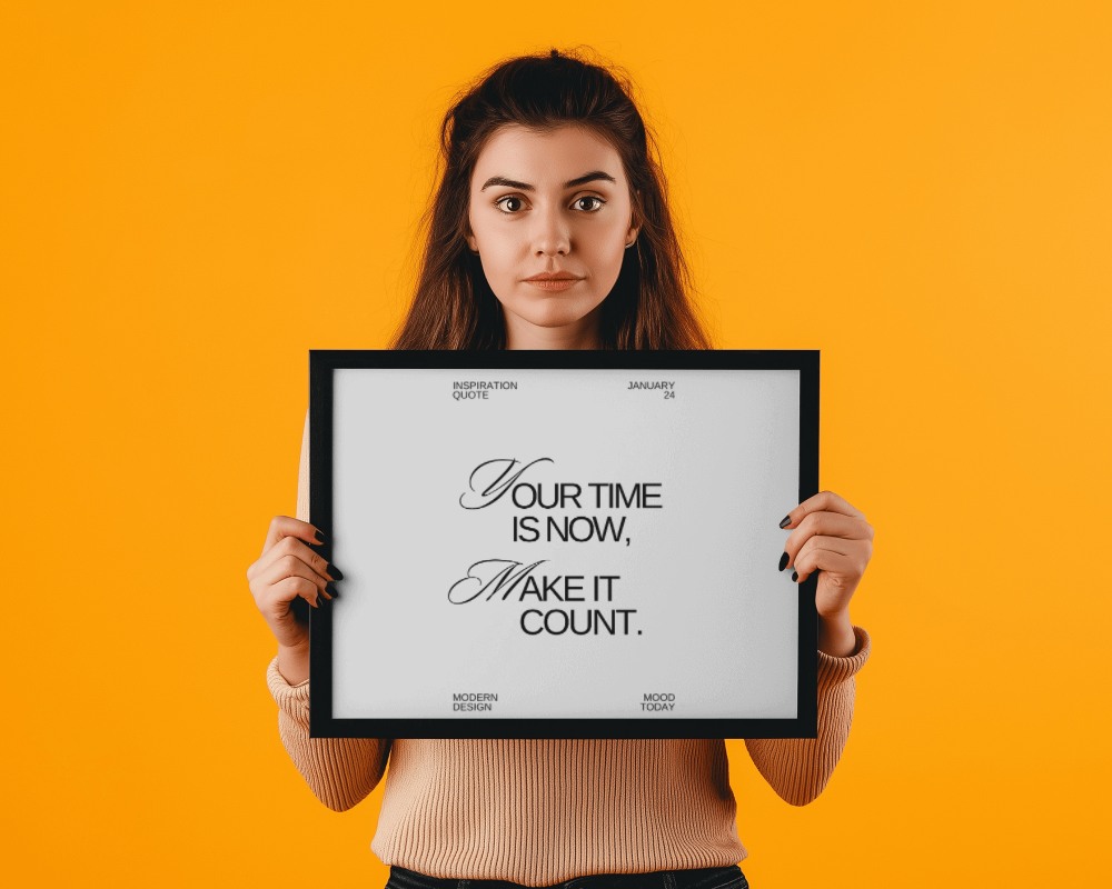 Framed Wall Art Mockup Held By Female Model With Vibrant Yellow Background
