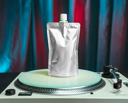 Glossy Spouted Pouch Mockup On Vinyl Turntable Dramatic Blue Red Lighting Edgy Music Themed Scene