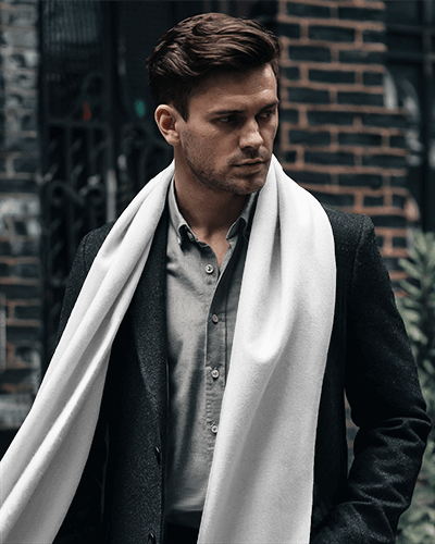 urban-stylish-scarf-mockup-male-model-in-white-scarf-and-dark-wool-coat-walking-through-city-streets-modern-and-sophisticated-look