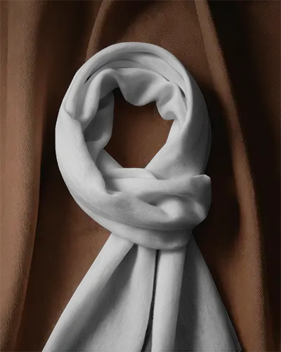 draped-textile-background-scarf-mockup-softly-twisted-fabric-posed-against-rich-brown-curtain