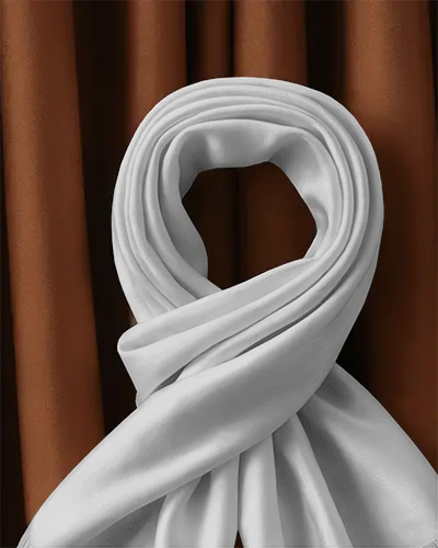 elegant-fabric-scarf-mockup-folded-in-loop-over-deep-brown-curtain-backdrop-for-luxury-presentation