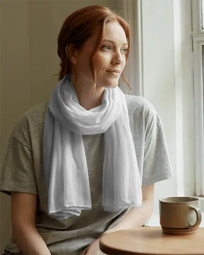 casual-home-scarf-mockup-on-woman-in-neutral-tee-gazing-outside-in-gentle-window-light-setting-047