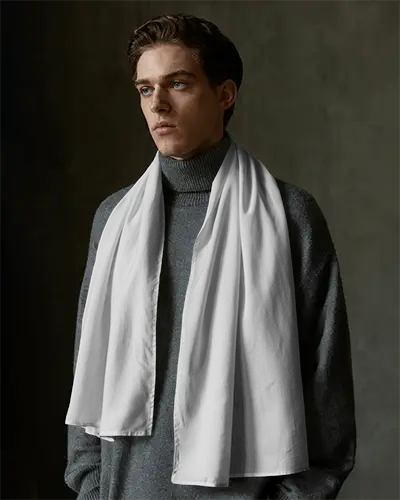 editorial-menswear-scarf-mockup-in-minimal-studio-setting-with-white-scarf-and-serious-expression-048