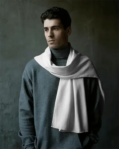 cinematic-menswear-scarf-mockup-on-model-gazing-away-in-soft-light-with-elegant-winter-styling-049
