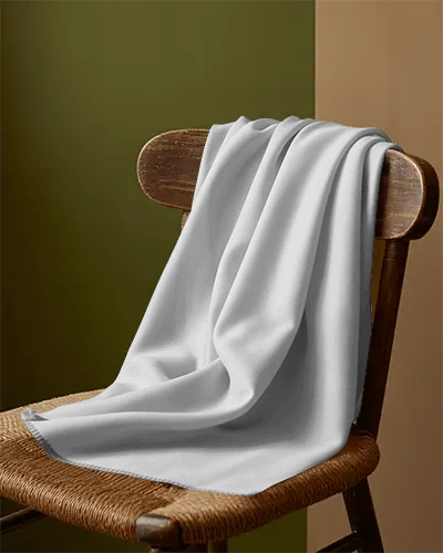 Photorealistic Scarf Mockup Fabric Accessory Draped On Chair In Studio With Green And Beige Backdrop