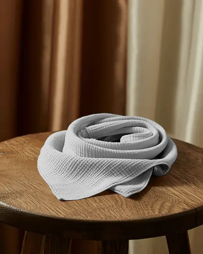 elegant-scarf-mockup-folded-display-on-wooden-stool-with-curtain-background
